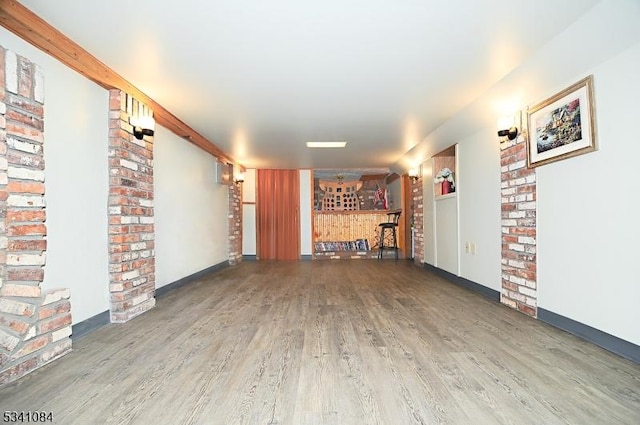 interior space with baseboards and wood finished floors