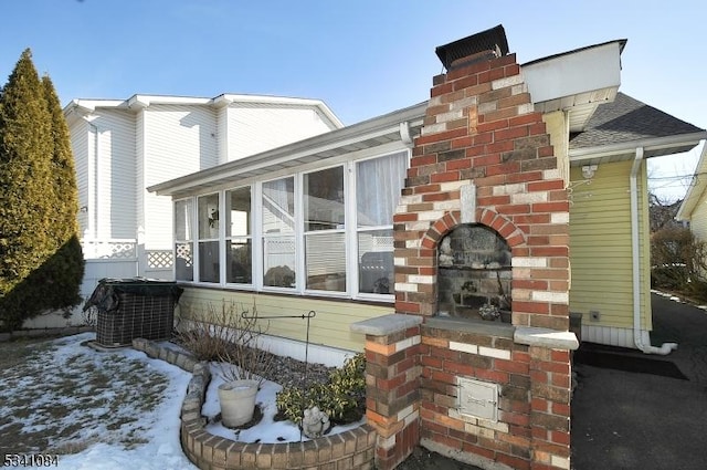 exterior space featuring a sunroom and a chimney