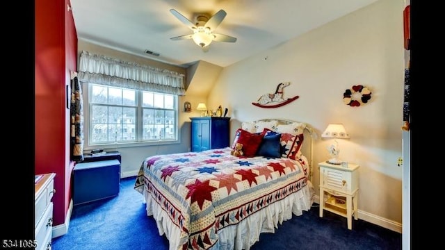 bedroom with ceiling fan, dark colored carpet, and baseboards