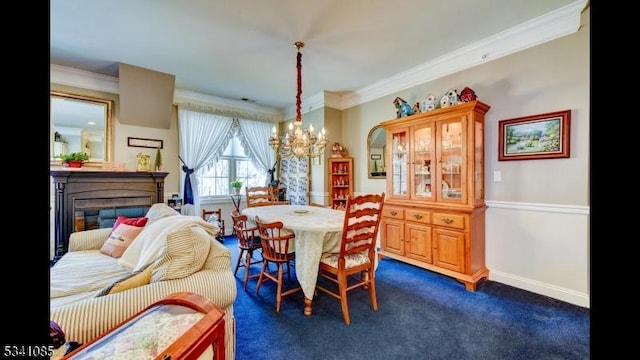 dining space featuring baseboards, a glass covered fireplace, an inviting chandelier, dark colored carpet, and crown molding