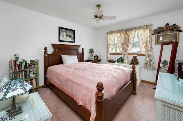 bedroom featuring light carpet, ceiling fan, and baseboards