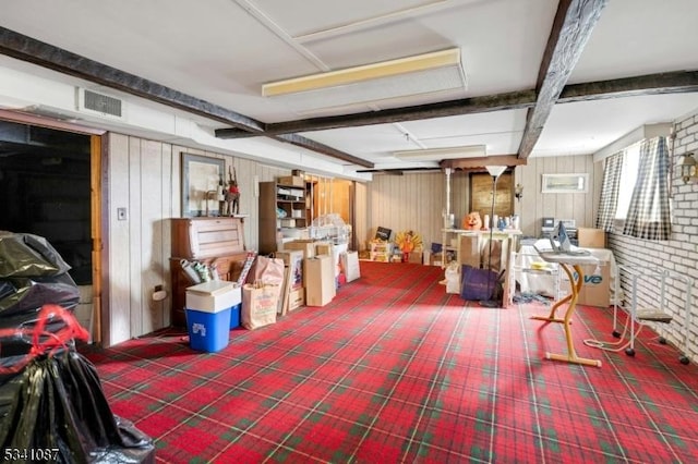 basement featuring visible vents and wooden walls