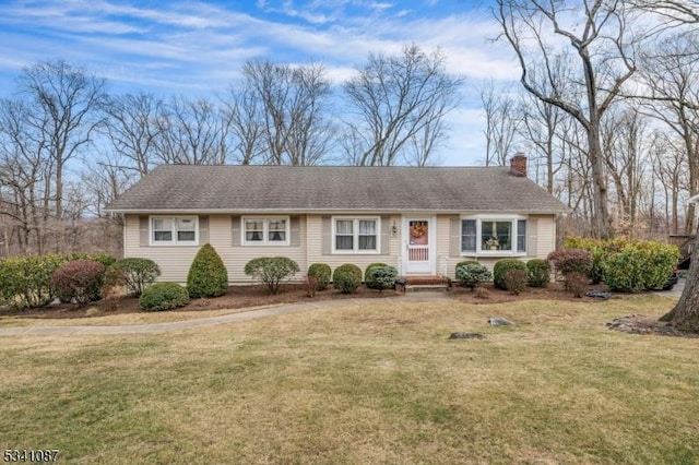 single story home with a front yard and a chimney