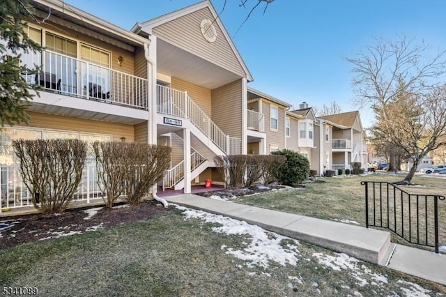 view of property featuring stairway and a residential view