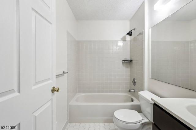 full bathroom featuring a textured ceiling, toilet, tub / shower combination, and vanity