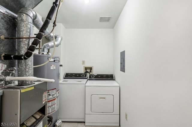 laundry room with laundry area, electric panel, visible vents, independent washer and dryer, and gas water heater