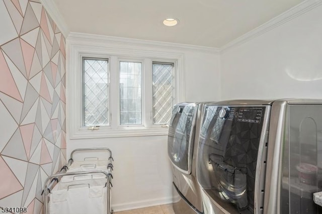 clothes washing area featuring laundry area, crown molding, and washer and clothes dryer