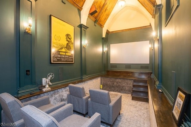 home theater featuring vaulted ceiling and baseboards