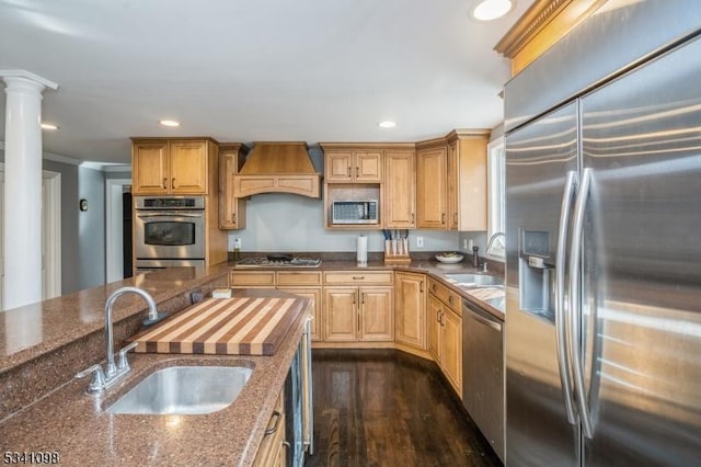 kitchen featuring stainless steel appliances, custom exhaust hood, a sink, and recessed lighting