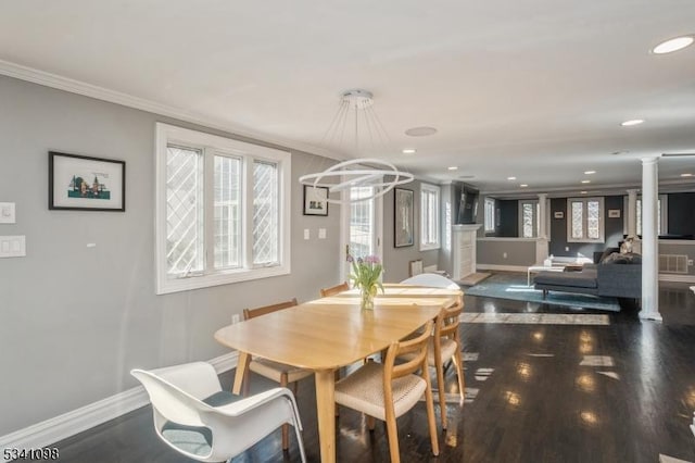 dining space with recessed lighting, wood finished floors, baseboards, decorative columns, and crown molding