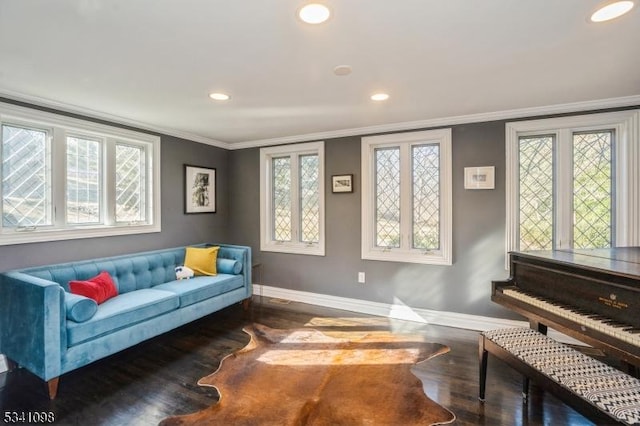 sitting room with baseboards, recessed lighting, wood finished floors, and crown molding