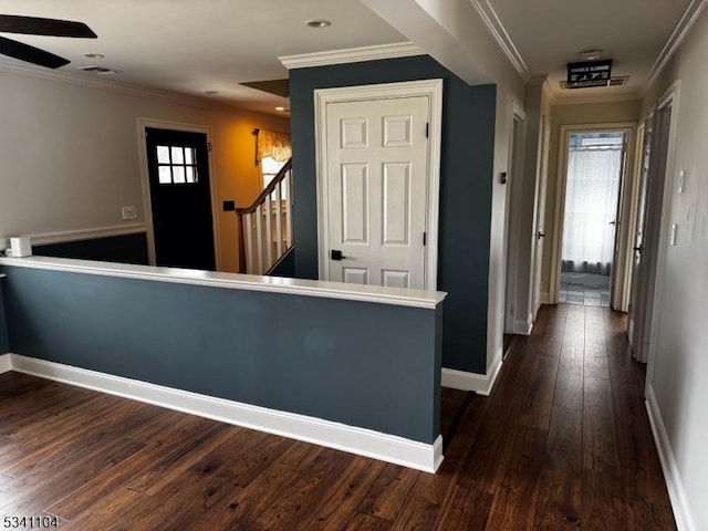 corridor featuring visible vents, baseboards, dark wood finished floors, recessed lighting, and ornamental molding