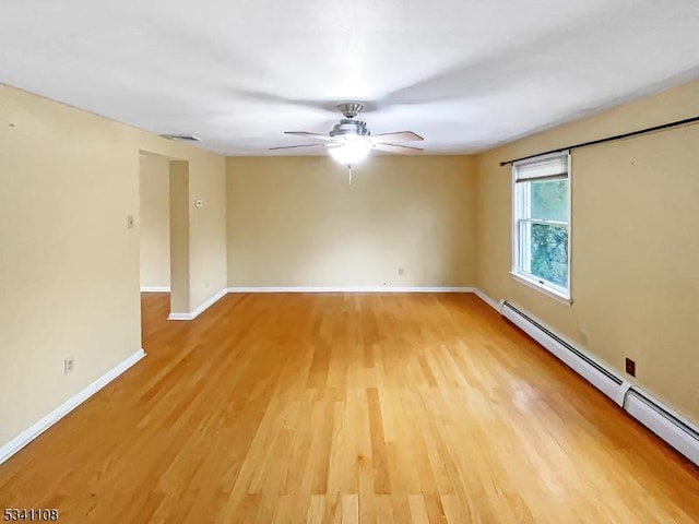 empty room with a ceiling fan, baseboards, light wood finished floors, and baseboard heating