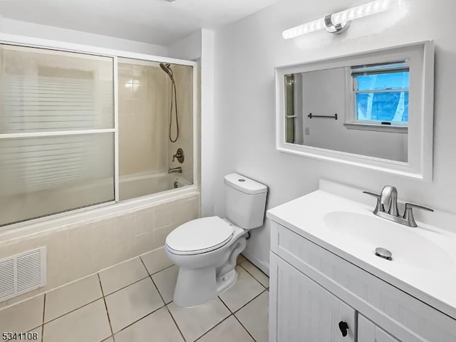 bathroom with visible vents, toilet, tile patterned floors, tiled shower / bath, and vanity