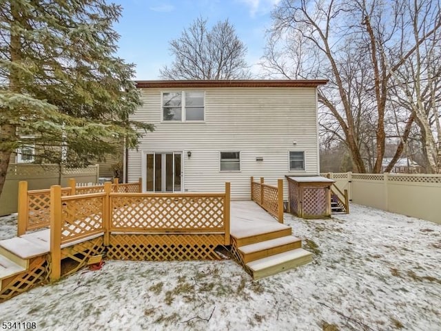 rear view of property featuring fence and a deck