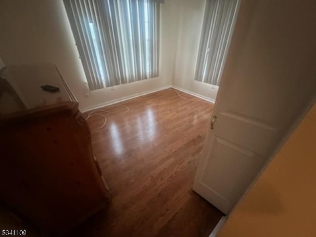 spare room featuring wood finished floors