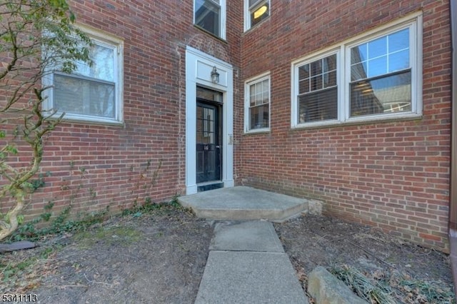 property entrance featuring brick siding