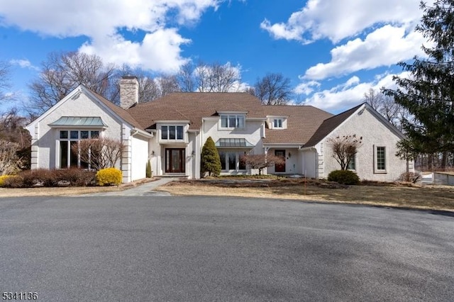 view of front of house with a garage and a chimney