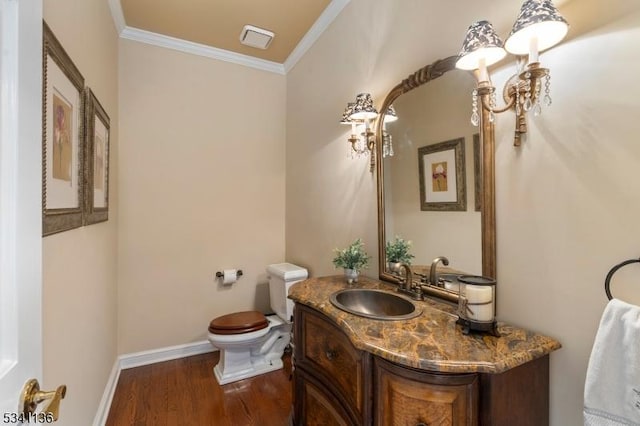 half bath with baseboards, visible vents, toilet, ornamental molding, and wood finished floors