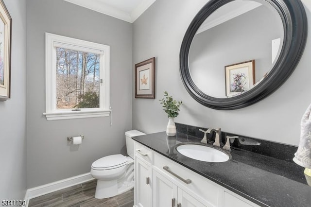 half bath featuring baseboards, toilet, wood tiled floor, crown molding, and vanity