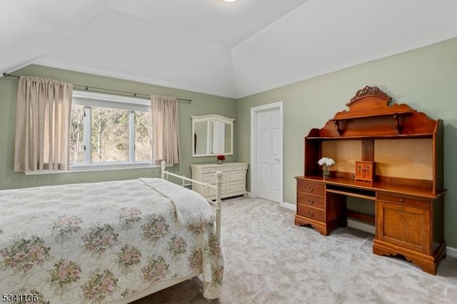 bedroom with light carpet, baseboards, and vaulted ceiling