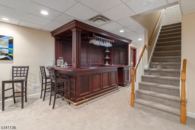 bar with a dry bar, light carpet, baseboards, stairway, and recessed lighting