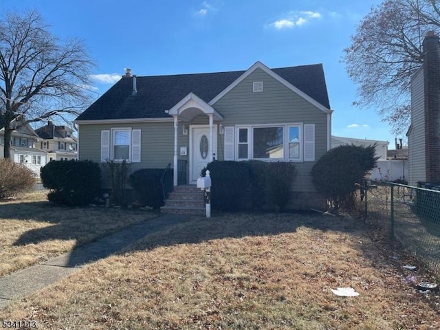 bungalow with fence and a front lawn