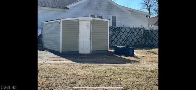 view of shed featuring fence