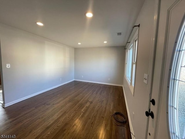 spare room featuring recessed lighting, visible vents, dark wood finished floors, and baseboards