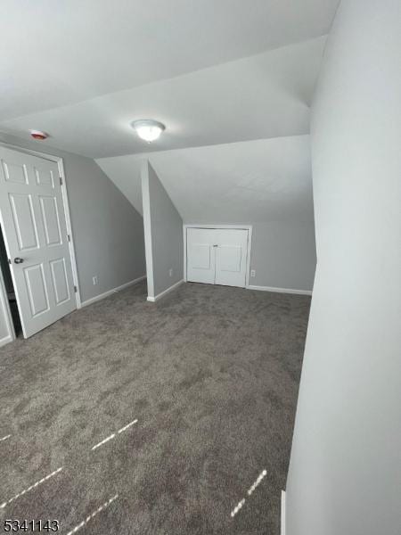 bonus room with carpet, vaulted ceiling, and baseboards