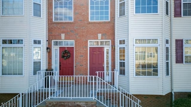 view of exterior entry with brick siding