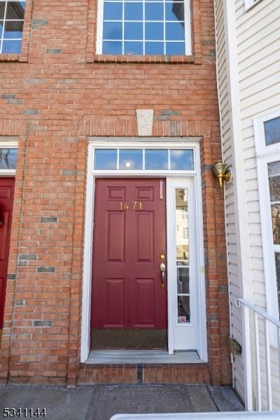 view of exterior entry featuring brick siding