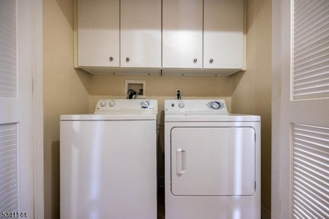 laundry area with cabinet space and washing machine and dryer