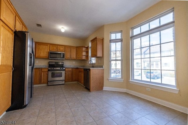 kitchen with visible vents, baseboards, light countertops, stainless steel appliances, and open shelves