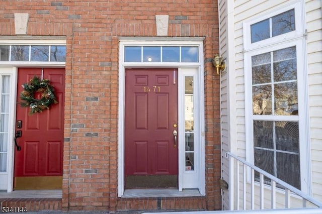 property entrance featuring brick siding