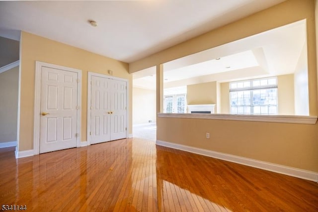 unfurnished bedroom featuring baseboards and wood-type flooring