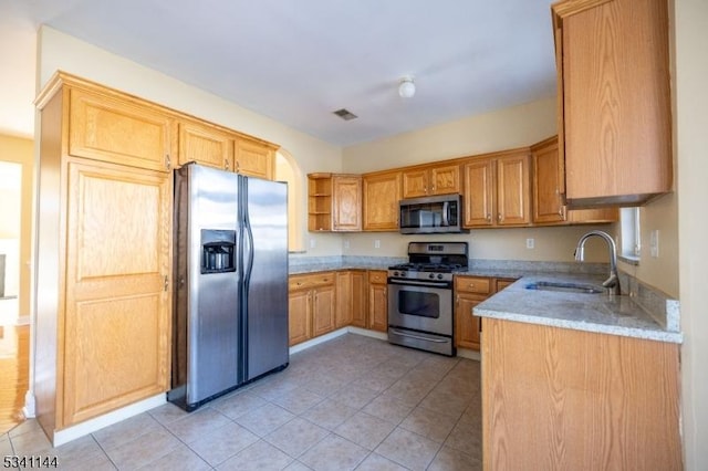 kitchen with visible vents, a sink, light tile patterned floors, stainless steel appliances, and open shelves