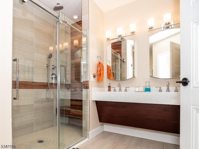 full bath featuring double vanity, baseboards, a sauna, a shower stall, and a sink