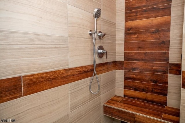 bathroom with tiled shower