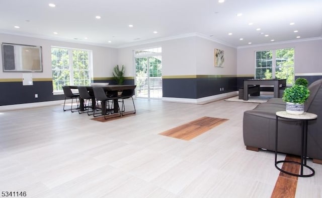 living area with baseboards, ornamental molding, and recessed lighting