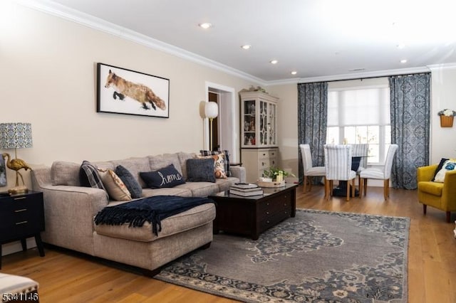 living room featuring ornamental molding, recessed lighting, and wood finished floors