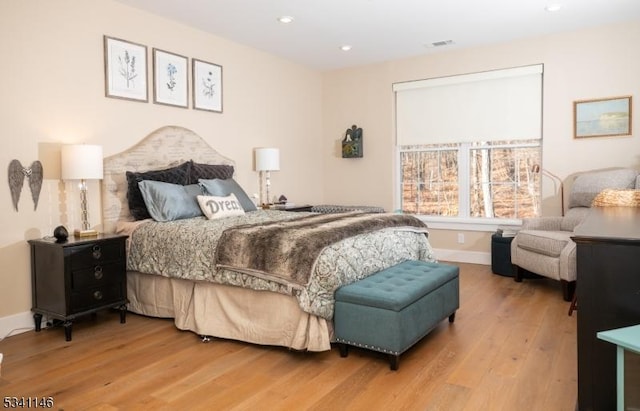 bedroom with recessed lighting, baseboards, and wood finished floors