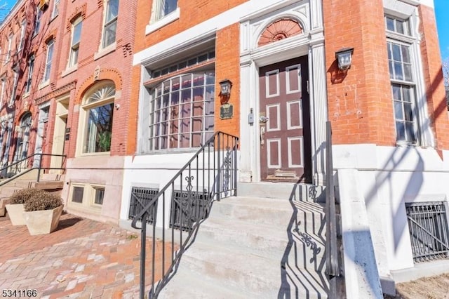 property entrance with brick siding