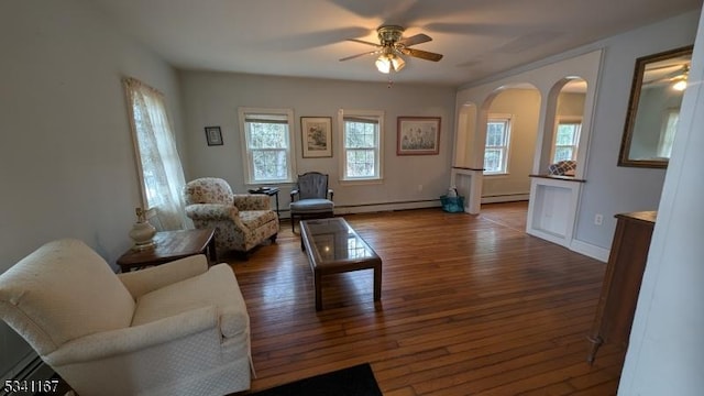 living area with a baseboard radiator, ceiling fan, and hardwood / wood-style floors