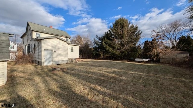 exterior space featuring a lawn and a chimney