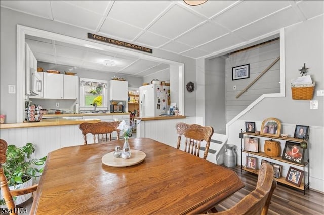 dining space with stairway and wood finished floors