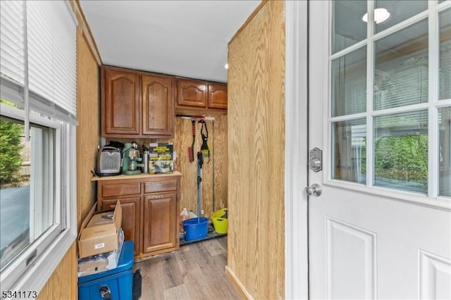 interior space featuring brown cabinetry and wood finished floors