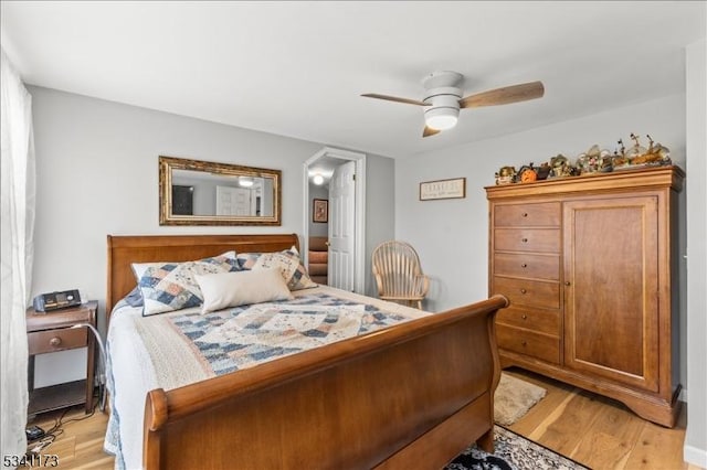 bedroom with light wood-type flooring and a ceiling fan