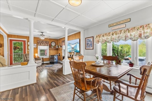 dining area with ornate columns, a ceiling fan, and wood finished floors