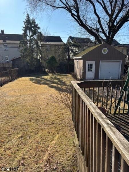 view of yard with a garage, an outdoor structure, and fence